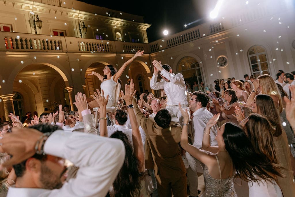 Newlyweds celebrate with guests on the dance floor at their reception at villa miani in rome