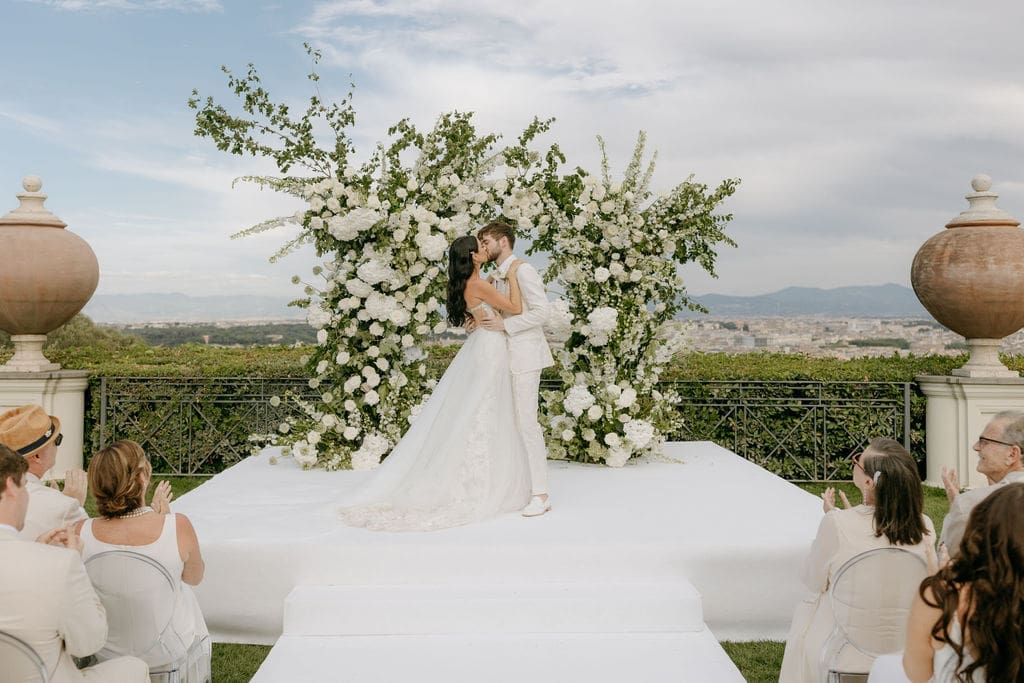 Newlyweds share a kiss at their Villa Miani ceremony planned by destination wedding planner, Wild Heart Events 